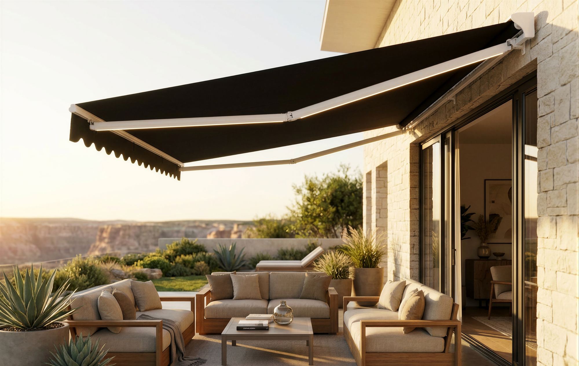 A SolarShield retractable awning extended over a furnished stone patio at sunset